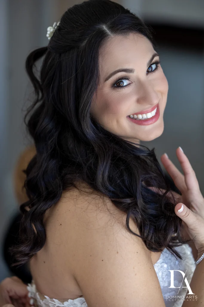 brunette bride getting ready after knowing how to choose a wedding hair and makeup artist