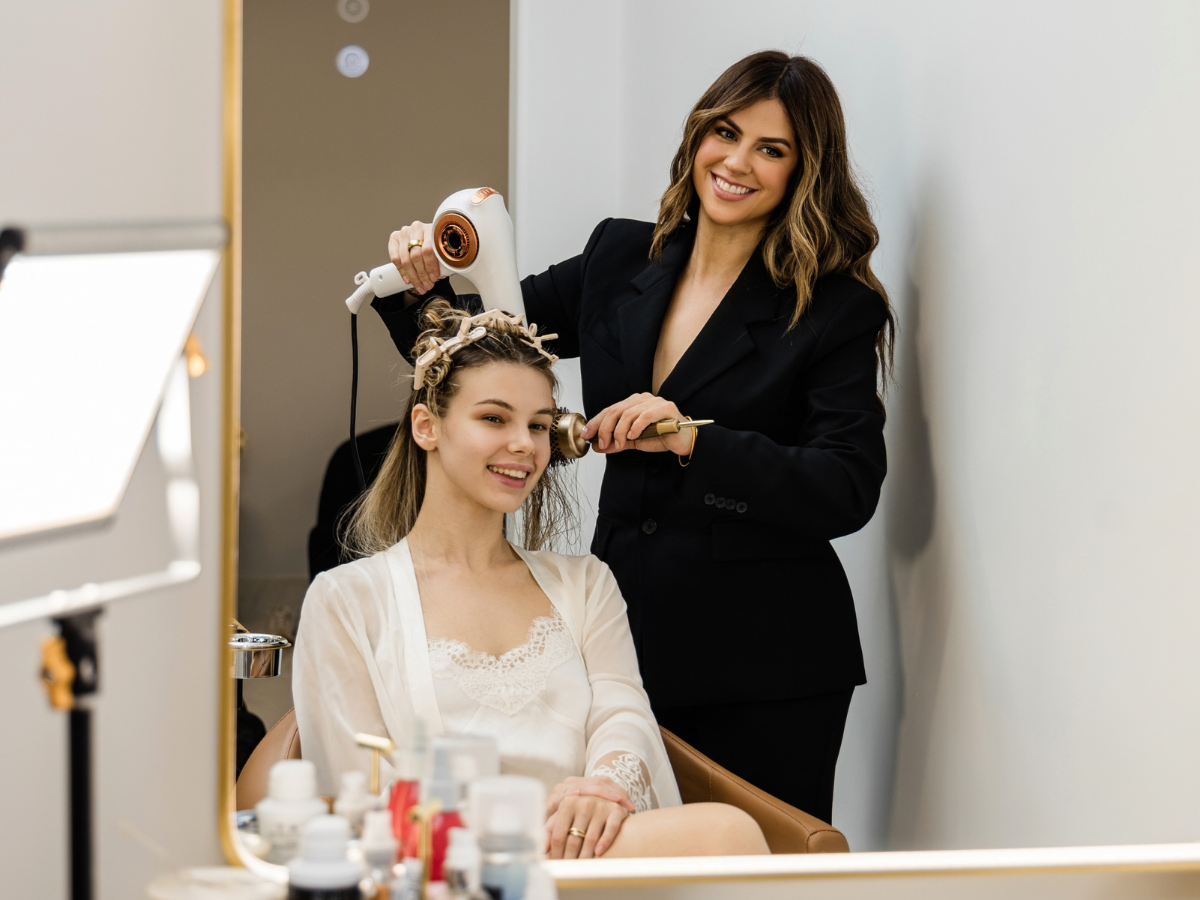 Jess Bonilla doing hair for a client at Jess Bonilla Beauty Studio in Boca Raton, South Florida